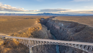 A silver-colored bridge spanning a deep chasm
