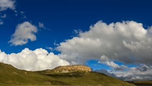 A plateau seen in the distance against a dark blue sky