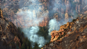 Smoke rising from a deep chasm in the mountains