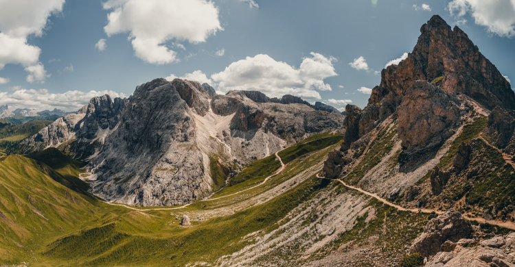 Mountains and valleys against a blue sky with clouds