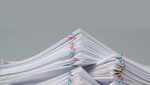 Batches of paper-clipped paper piled up like mountains