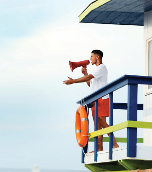 A lifeguard making an announcement through a megaphone