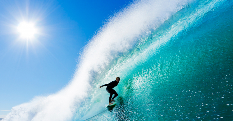 A surfer expertly riding a big wave