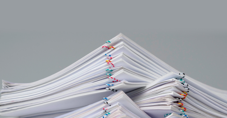 Batches of paper-clipped paper piled up like mountains